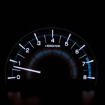 white and blue analog tachometer gauge
