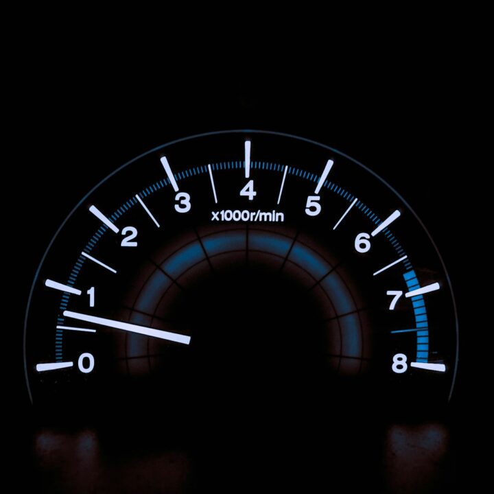 white and blue analog tachometer gauge
