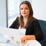 woman in black blazer using MacBook